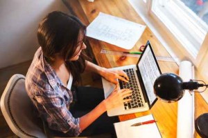 Young female blogger working at home.She sitting in her working